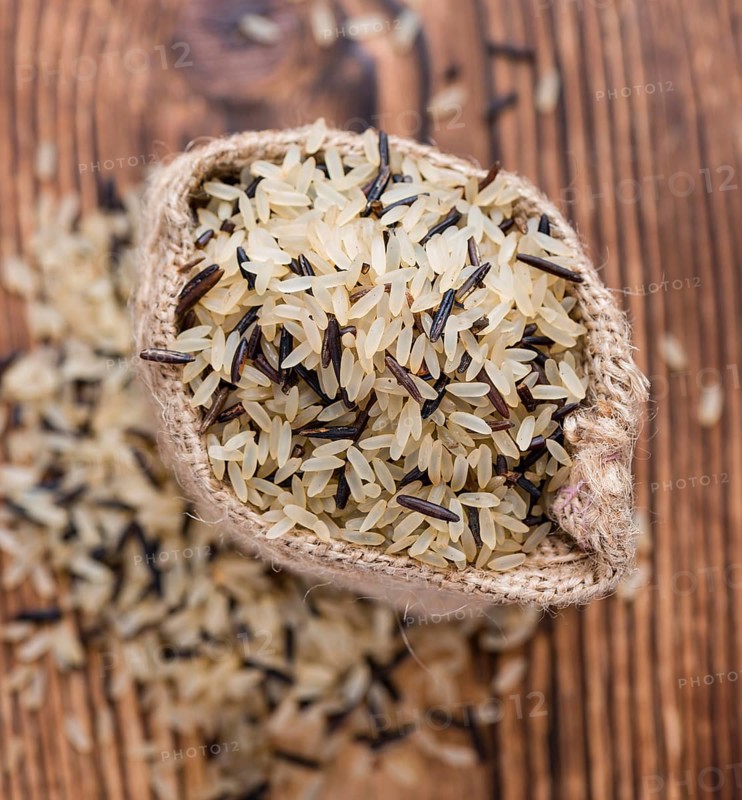 Portion of Mixed Rice (close-up shot) on wooden background