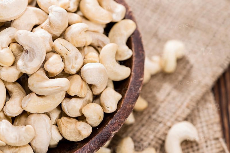 Portion of dried Cashew Nuts (detailed close-up shot)