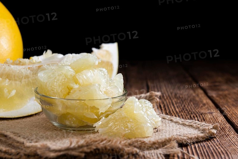 Fresh pieces of Pomelo (close-up shot) on vintage background