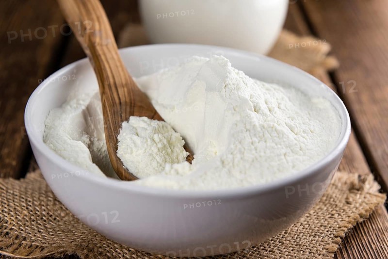 Portion of Milk Powder (selective focus) on an old wooden table