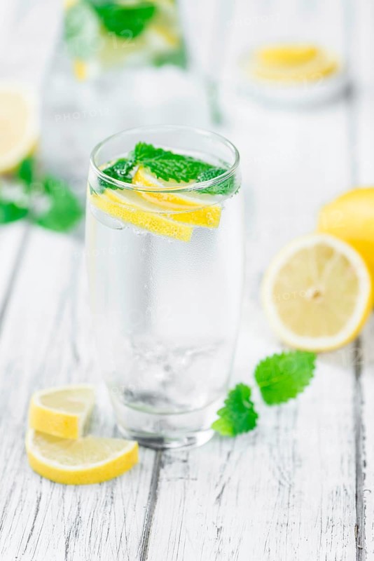 Homemade Lemonade on an wooden table (selective focus) as detailed close-up shot