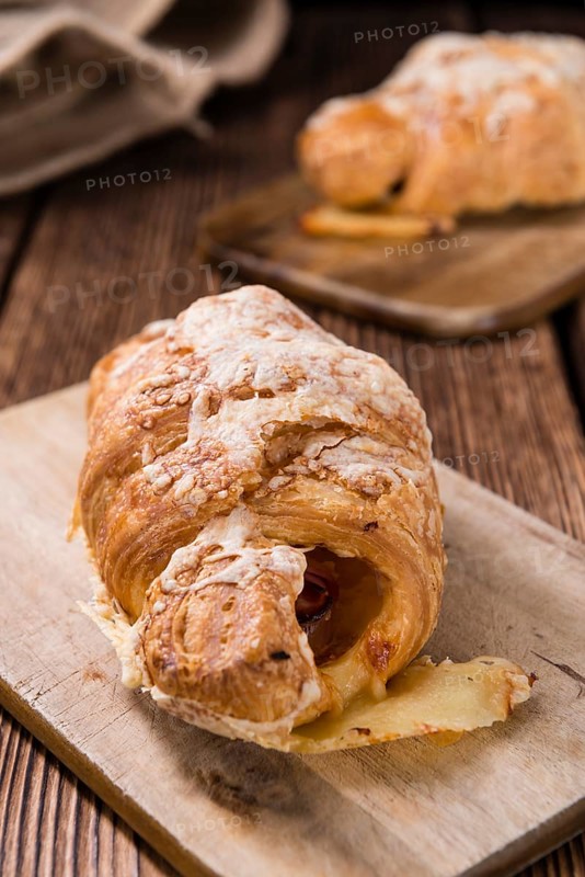 Homemade Ham and Cheese Croissant (selective focus) on wooden background