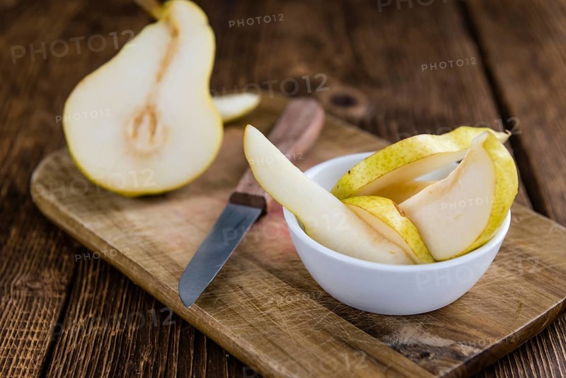 Pears (selective focus) on an old wooden table (close-up shot)