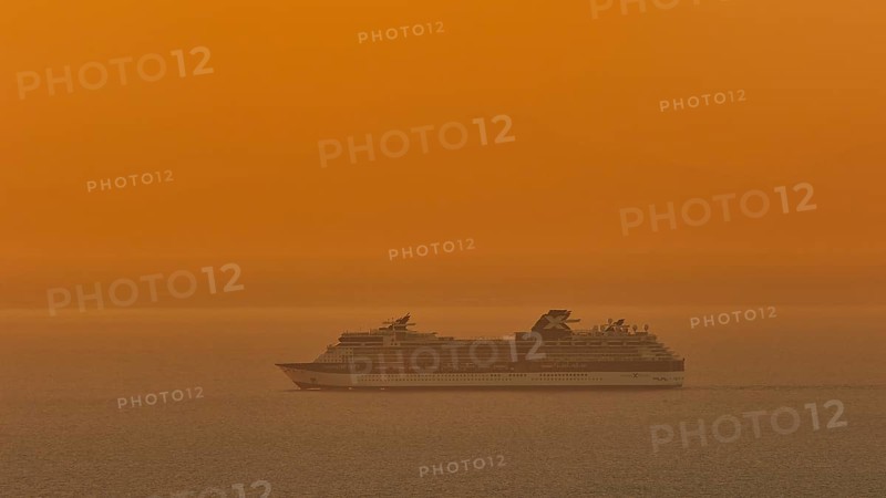 Large cruise ship sails through the calm, orange-coloured sea at sunset, Kritinia Castle, St John's Castle, Kritinia, Rhodes, Dodecanese, Greek Islands, Greece, Europe