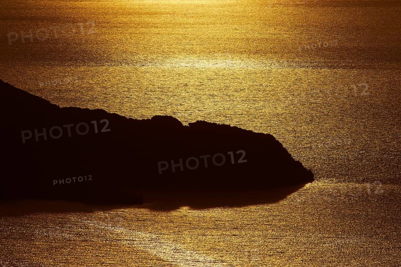 Coastal silhouette at sunset, the golden light reflected in the calm water, Kritinia Castle, St John's Castle, Kritinia, Rhodes, Dodecanese, Greek Islands, Greece, Europe