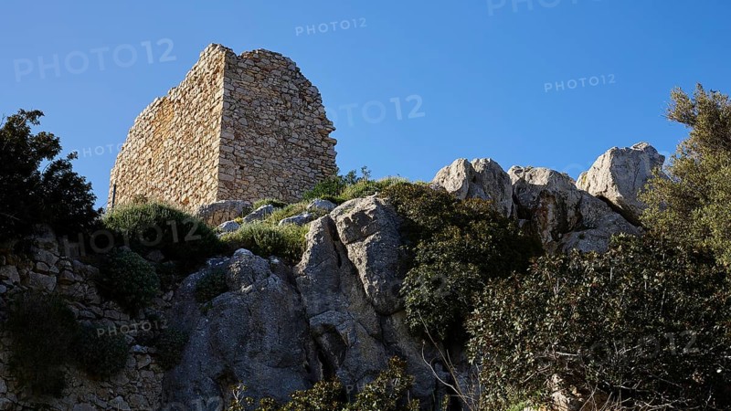 A historic ruin on rocky terrain with dense vegetation and blue sky, Kritinia Castle, St John's Castle, Kritinia, Rhodes, Dodecanese, Greek Islands, Greece, Europe