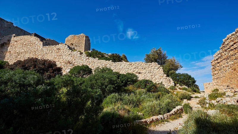 Path along the ruins of an ancient castle, surrounded by green vegetation and blue sky, Kritinia Castle, St John's Castle, Kritinia, Rhodes, Dodecanese, Greek Islands, Greece, Europe