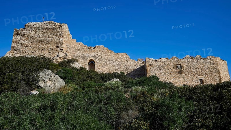 Ruins of an old building under a clear blue sky, surrounded by green overgrown grounds, Kritinia Castle, St John's Castle, Kritinia, Rhodes, Dodecanese, Greek Islands, Greece, Europe