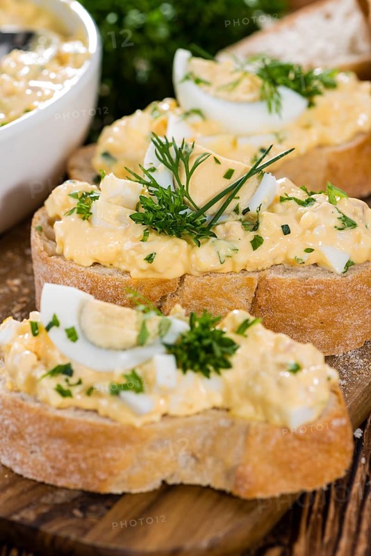 Piece of Bread with fresh homemade Egg Salad (close-up shot)