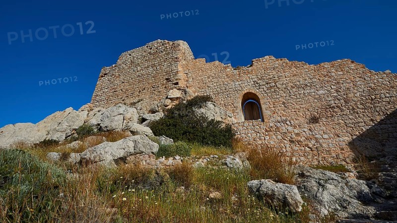 Ruins of a castle with partially preserved walls and a window, surrounded by vegetation under a clear sky, Kritinia Castle, St John's Castle, Kritinia, Rhodes, Dodecanese, Greek Islands, Greece, Europe