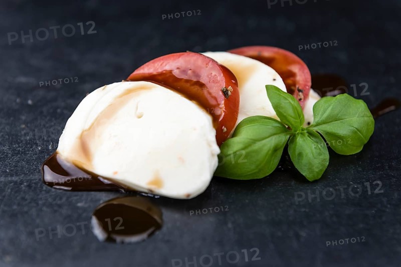 Portion of Mozzarella with Tomatoes (detailed close-up shot, selective focus)