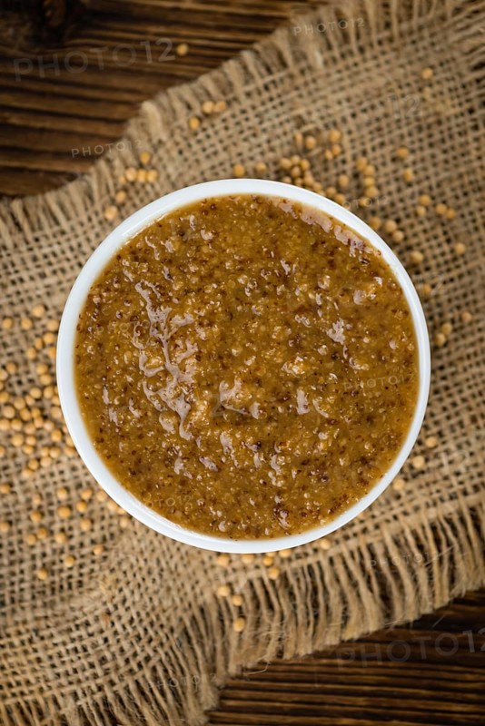 Fresh made German Cuisine (sweet Mustard) on a vintage background (close-up shot)