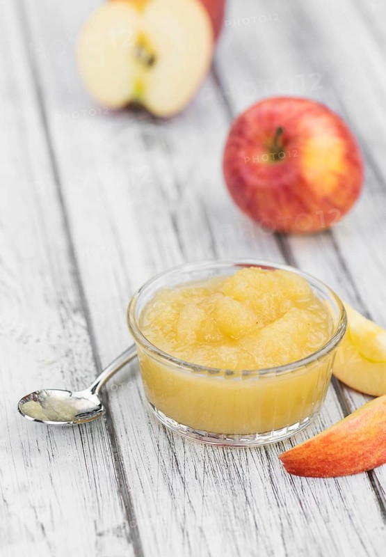 Homemade Applesauce (selective focus, close-up shot) on vintage background with some fresh fruits