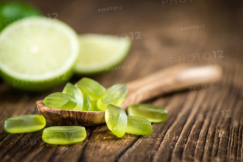 Gummy Candy with lime taste (selective focus) on wooden background
