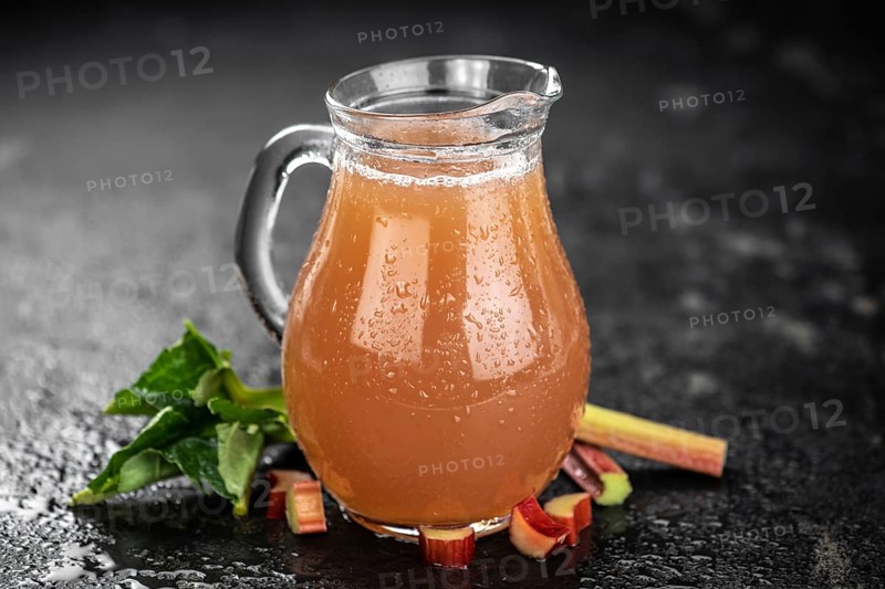 Rhubarb Juice on a rustic background (close up shot, selective focus)