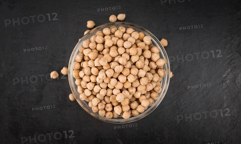 Portion of dried Chickpeas on a rustic slate slab, selective focus, close-up shot
