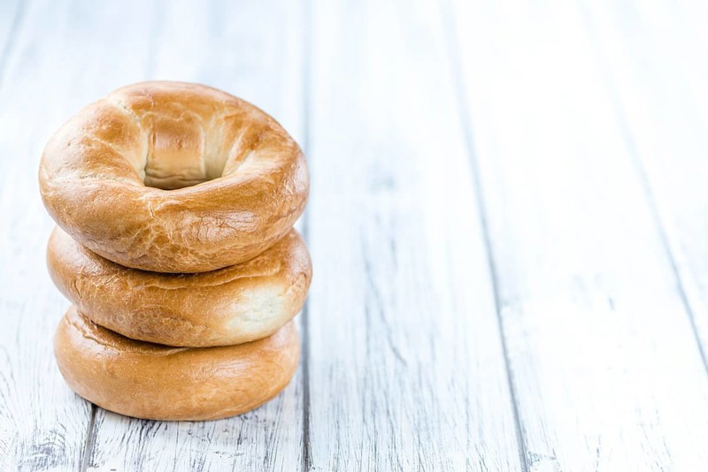 Plain Bagel (selective focus) on vintage background (close-up shot)