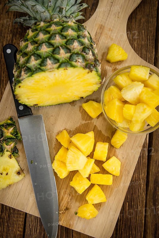 Fresh made Pineapple (sliced) on a vintage background as detailed close-up shot