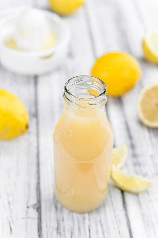Fresh made Juice (lemon) on a vintage background (close-up shot)
