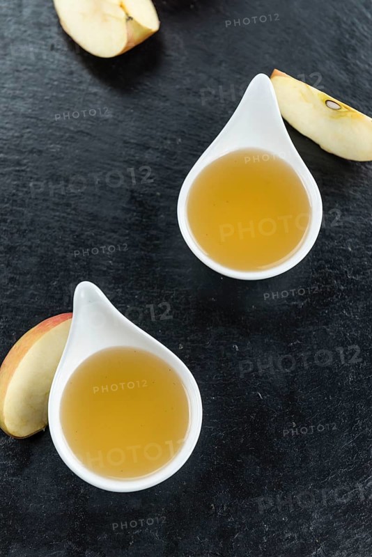 Portion of fresh made Applesauce (close-up shot) on vintage background
