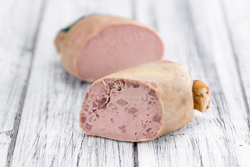 Liverwurst (German cuisine) as high detailed close-up shot on a vintage wooden table (selective focus)
