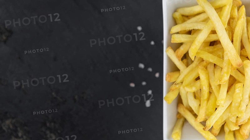 Portion of fresh made French Fries (close-up shot, selective focus)