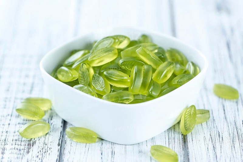 Portion of gummy candy (with lime taste) as close-up shot (selective focus)