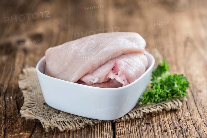 Wooden table with chicken cutlet (detailed close-up shot)