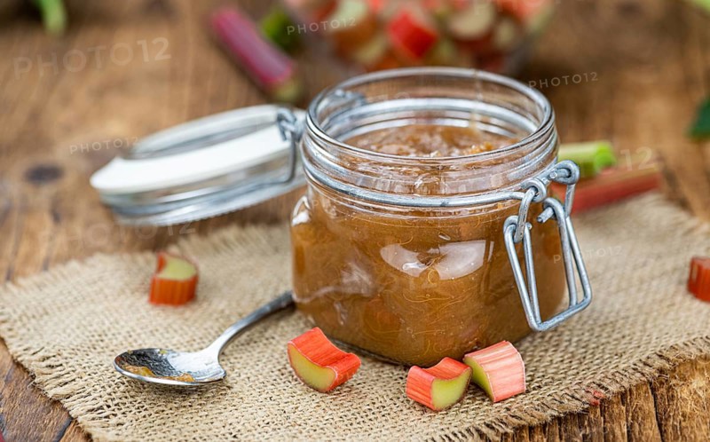 Rhubarb Jam on an old wooden table as detailed close up shot (selective focus)