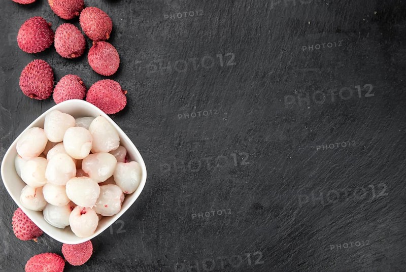 Portion of Litchis as detailed close up shot on a slate slab (selective focus)