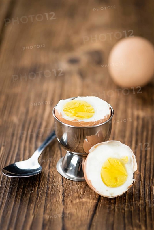 Wooden table with boiled Eggs (selective focus, close-up shot)