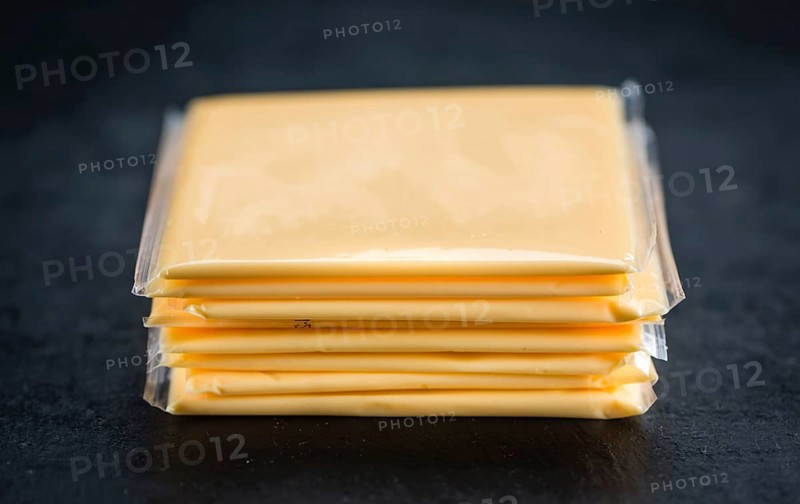 Portion of sliced Cheese (close-up shot, selective focus)