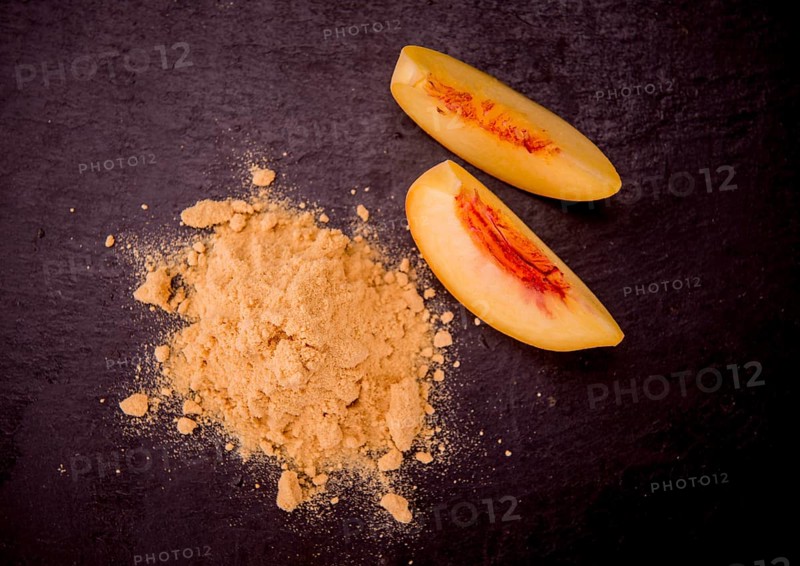 Peach powder on a vintage slate slab as detailed close-up shot, selective focus