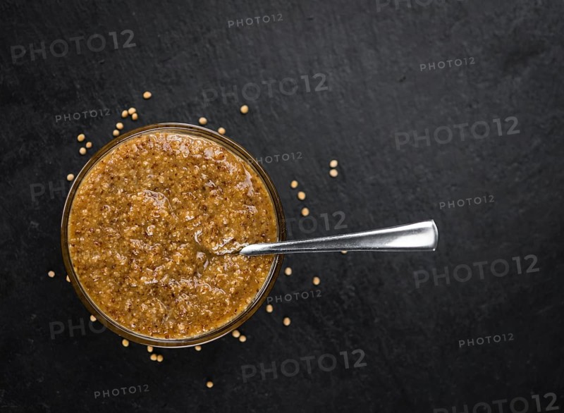 Fresh made German Cuisine (sweet Mustard) on a vintage background (close-up shot)