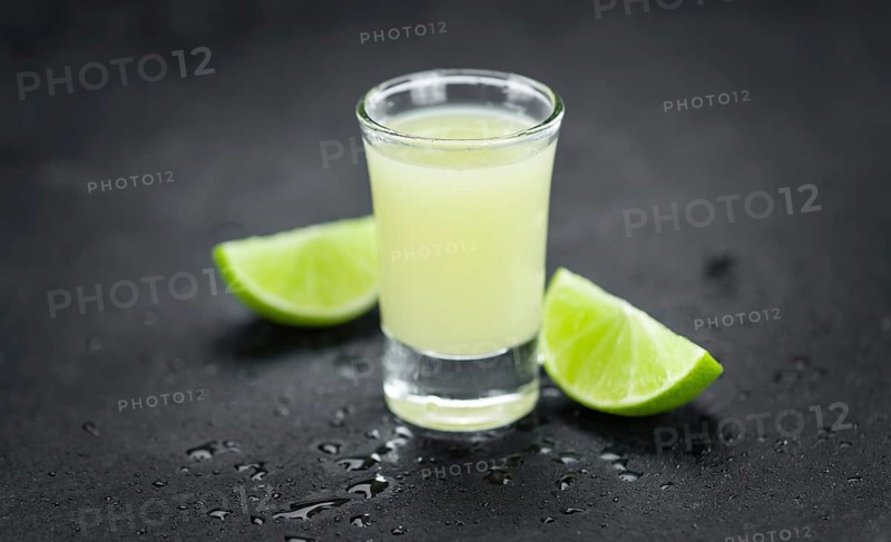 Portion of Fresh Lime Juice on a rustic slate slab (selective focus, close-up shot)