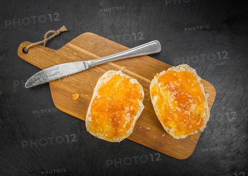 Portion of Peach Jam on a rustic slate slab, selective focus, close-up shot