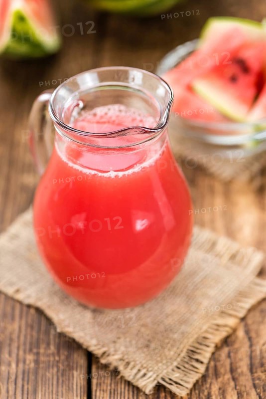 Watermelon Smoothie on rustic wooden background (close-up shot)