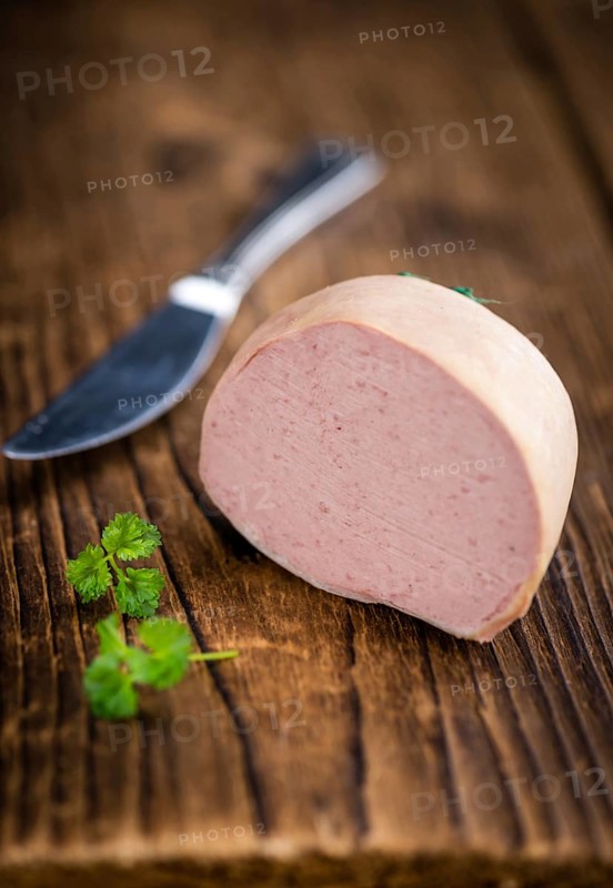 German Leberwurst on an old wooden table as detailed close-up shot (selective focus)