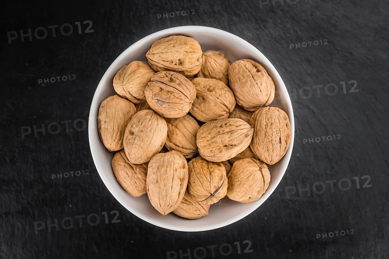 Walnuts on a vintage background as detailed close-up shot (selective focus)