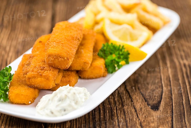 Fried Fish Fingers (selective focus) on wooden background (selective focus)