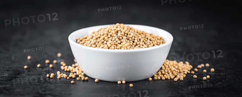 Portion of fresh made Mustard Seeds (close-up shot, selective focus)