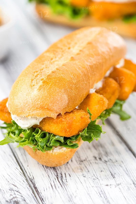 Sandwich with Fish Sticks (selective focus) on an old wooden table