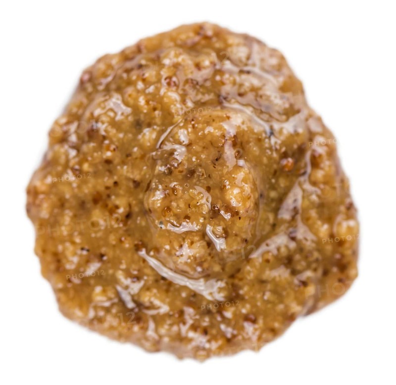 Portion of Sweet Mustard (as close-up shot) isolated on white background