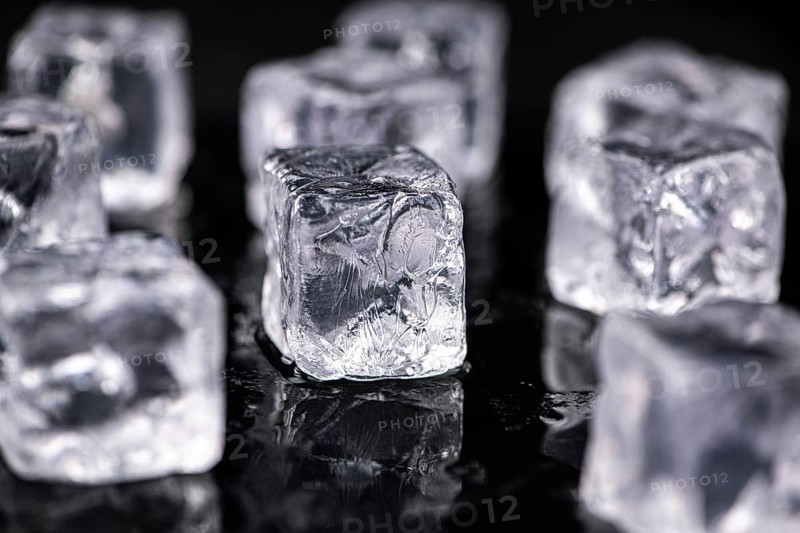 Ice Cubes on dark background as detailed close-up shot, selective focus