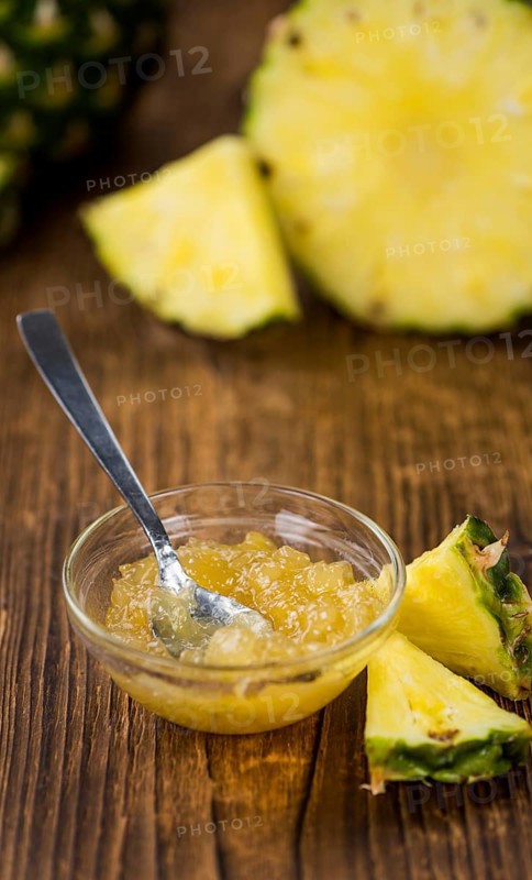 Fresh made Pineapple Jam on an old and rustic wooden table, selective focus, close-up shot