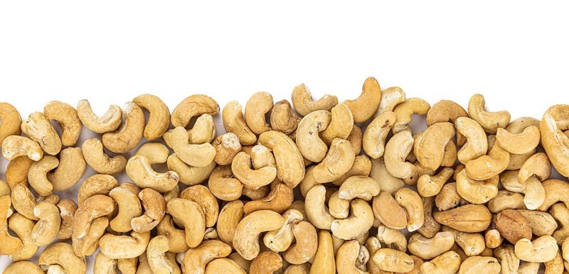 Cashew Nuts isolated on white background (close up shot, selective focus)