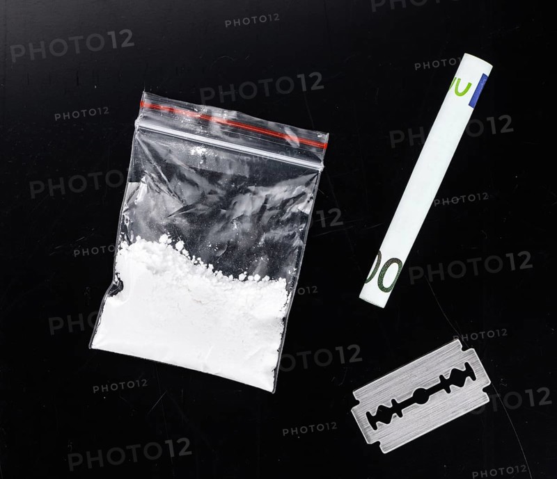 Dark plate with a portion of Cocaine as close-up shot
