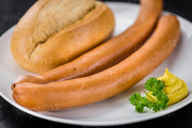 Sausages (Frankfurter) on a vintage slate slab (close-up shot, selective focus)
