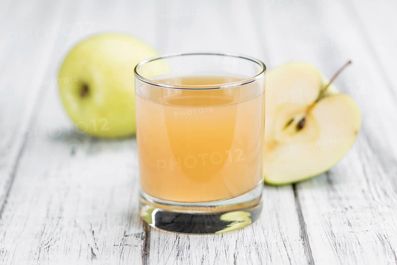 Apple Juice on a vintage background as detailed close-up shot (selective focus)