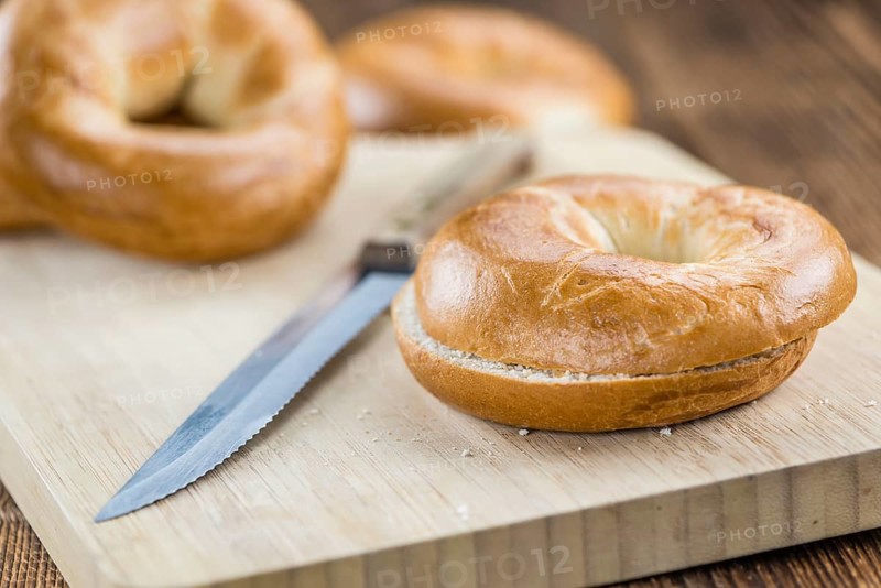 Fresh made plain Bagel (selective focus) on vintage background (close-up shot)
